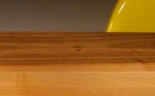wooden table with yellow & red chairs